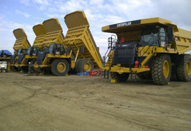 Row of CAT 777 haul trucks with systems installed